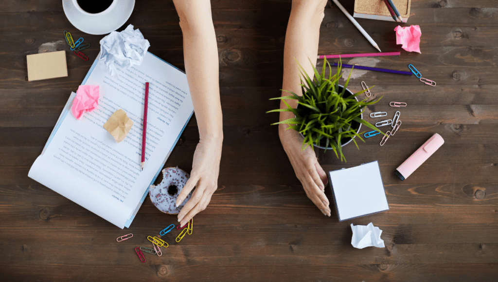 A business owner clearing space on a busy desk. Finding the right automation tools helps you simplify and streamline your business!