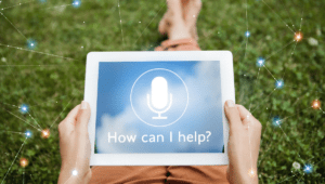 A woman holds a tablet on her lap that says “How can I help?” Learning how to delegate virtual assistant duties will help you get back to running your shit and growing your business.