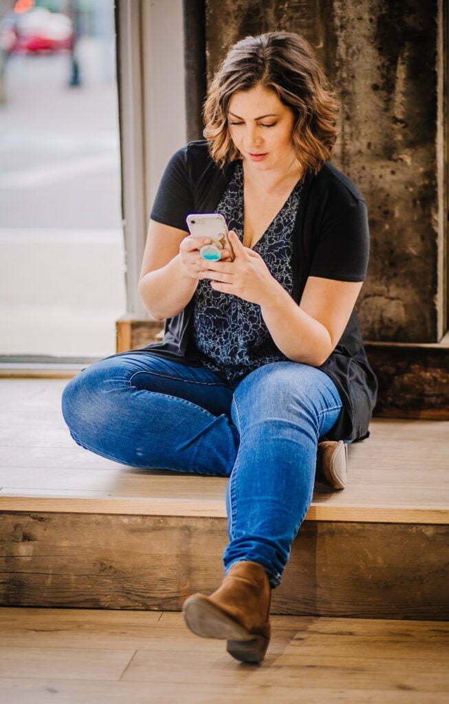 Erika Macauley works on her phone. Her Integrator Intensives help businesses take their operations to the next level.